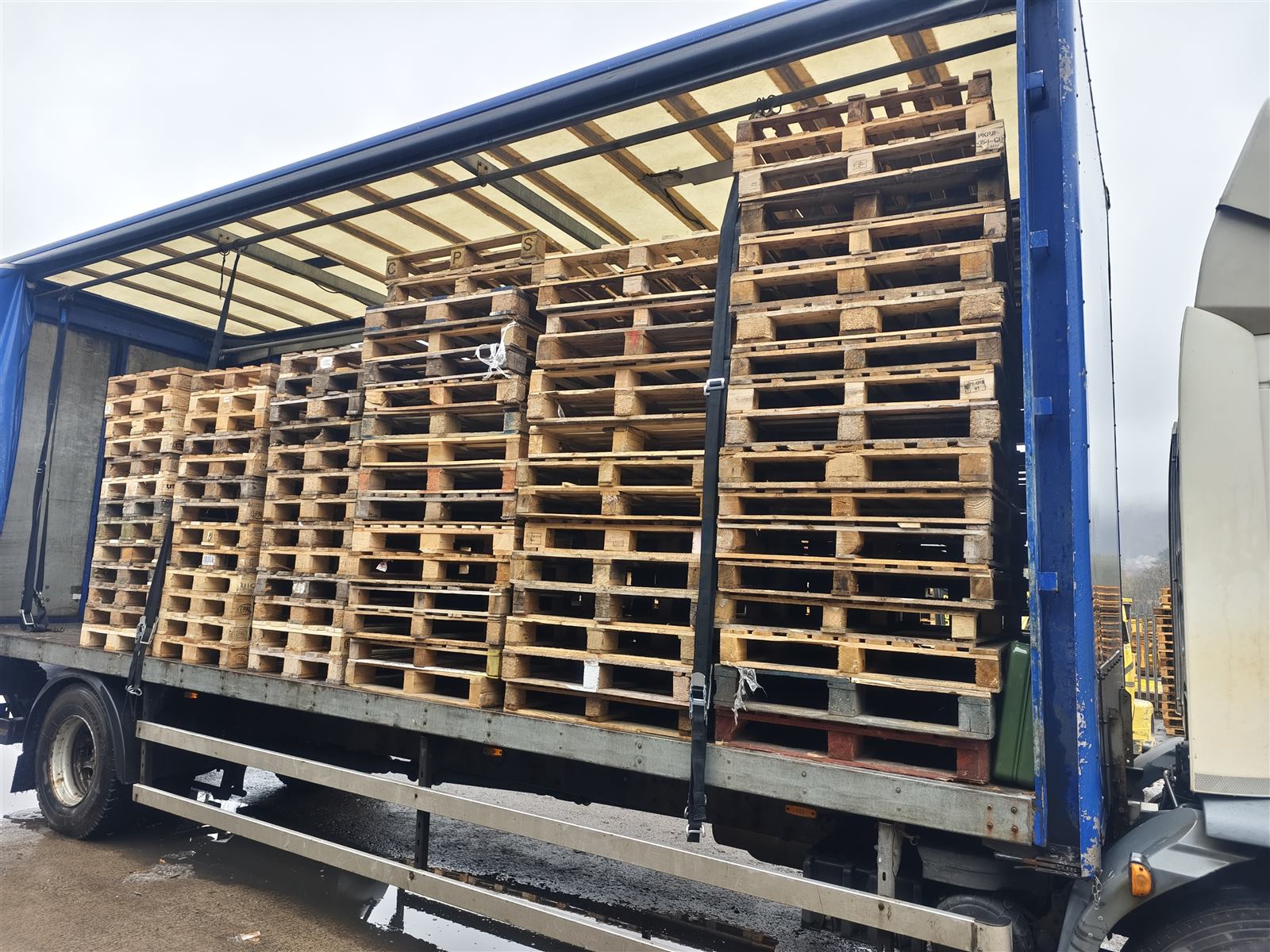 Surplus pallets collected from a South Wales business, stacked at the S&M Pallets yard in Port Talbot